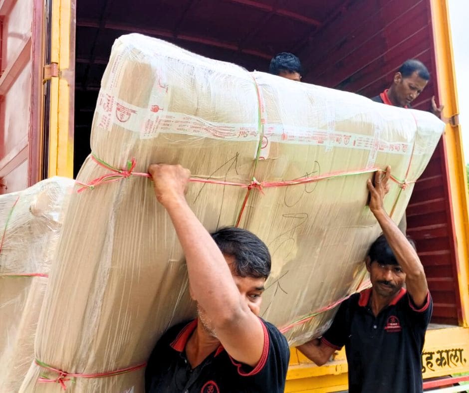 unloading packed bed from truck by packers movers team's